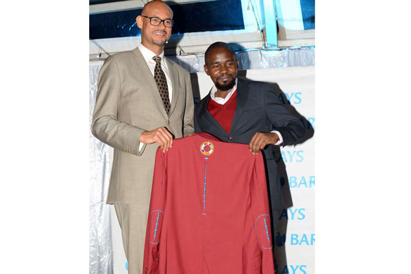 Barclays Bank of Kenya CEO Jeremy Awori (left) and fashion designer Nick Ondu at the Muthaiga Golf Club on March 22, 2018 during the unveiling of the Kenya Open ceremonial winner's jacket. PHOTO | Courtesy